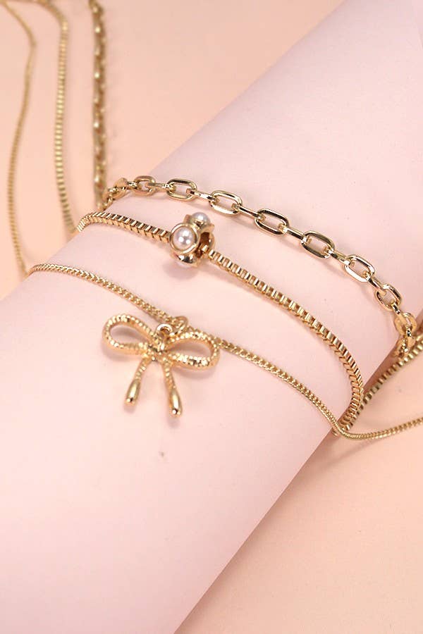 JOSSLYN by wall to wall - MULTI LAYER PEARL BOW CHARM NECKLACE | 80N605