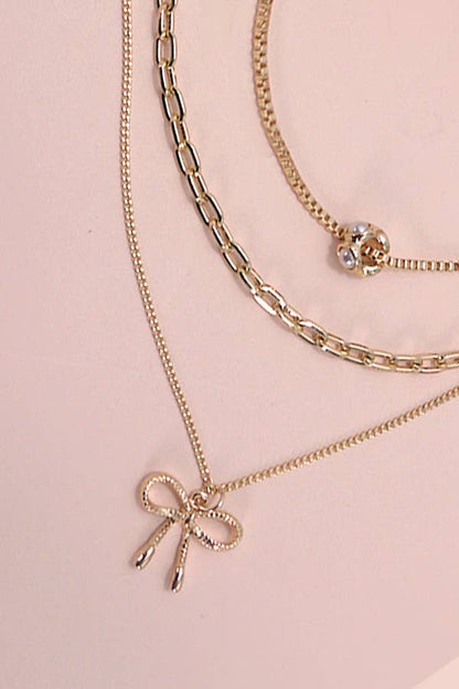 JOSSLYN by wall to wall - MULTI LAYER PEARL BOW CHARM NECKLACE | 80N605